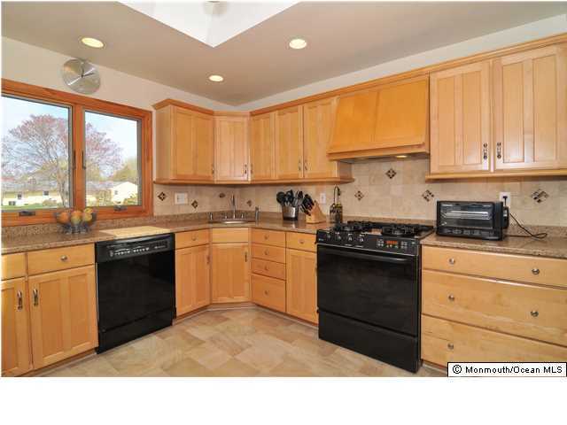 861 Colts Neck Road Freehold, NJ 07728 - Photo 10 of 25 a kitchen with a sink stove and white cabinets