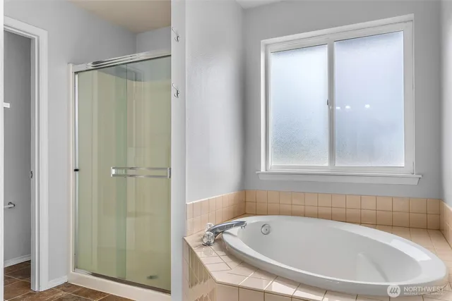 a bathroom with a tub and shower