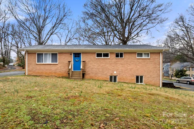 a house that has a tree in front of it