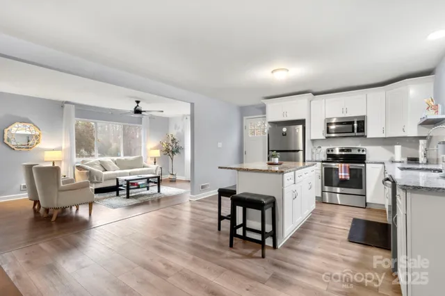 a living room with furniture a dining table and kitchen view