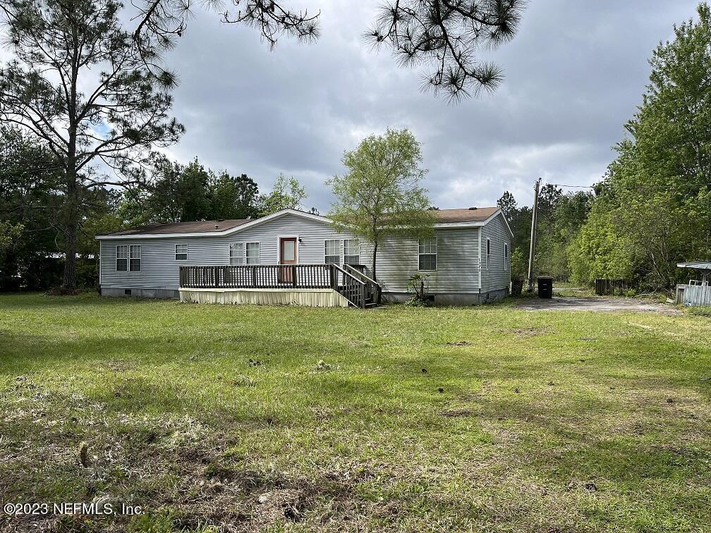 1370 Otis Road Jacksonville, FL 32220 - Photo 1 of 17 a front view of house with yard and trees
