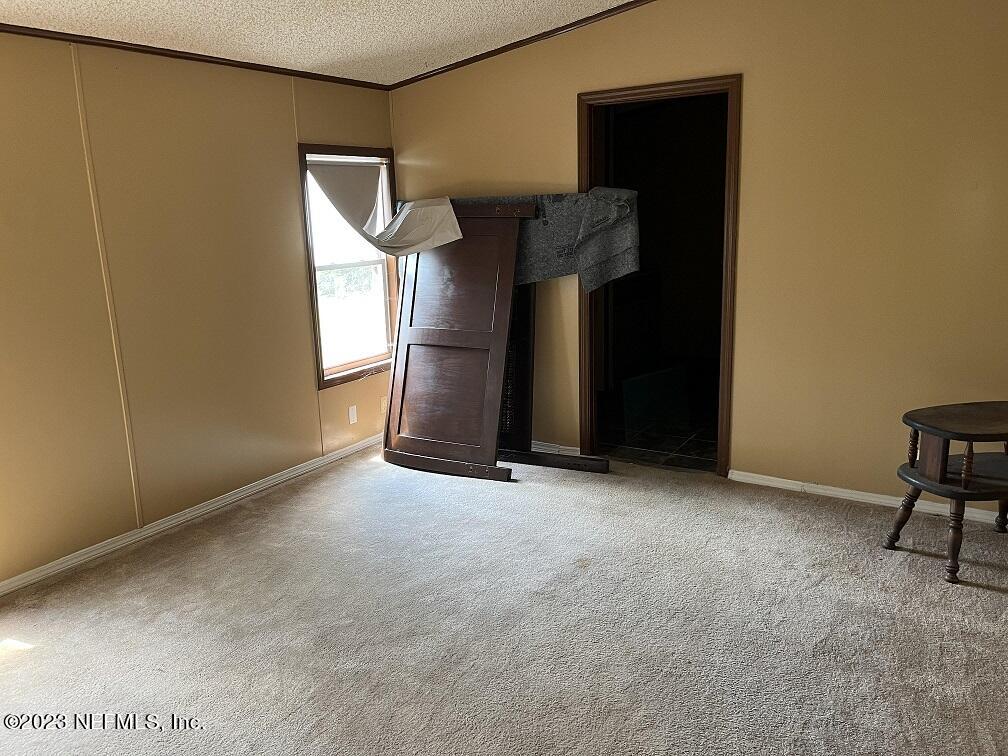 1370 Otis Road Jacksonville, FL 32220 - Photo 13 of 17 a view of an empty room with a fireplace and a window
