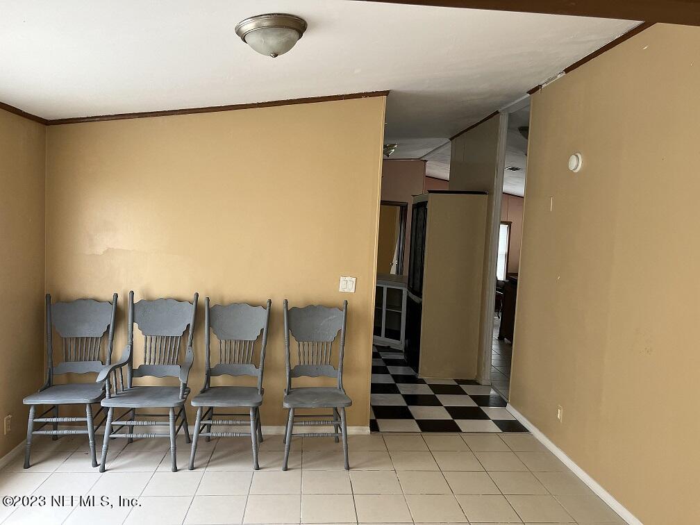 1370 Otis Road Jacksonville, FL 32220 - Photo 4 of 17 a view of kitchen with stainless steel appliances refrigerator stove dining table and chairs