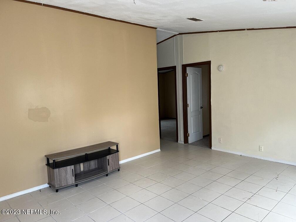 1370 Otis Road Jacksonville, FL 32220 - Photo 5 of 17 a room with a bench and cabinet