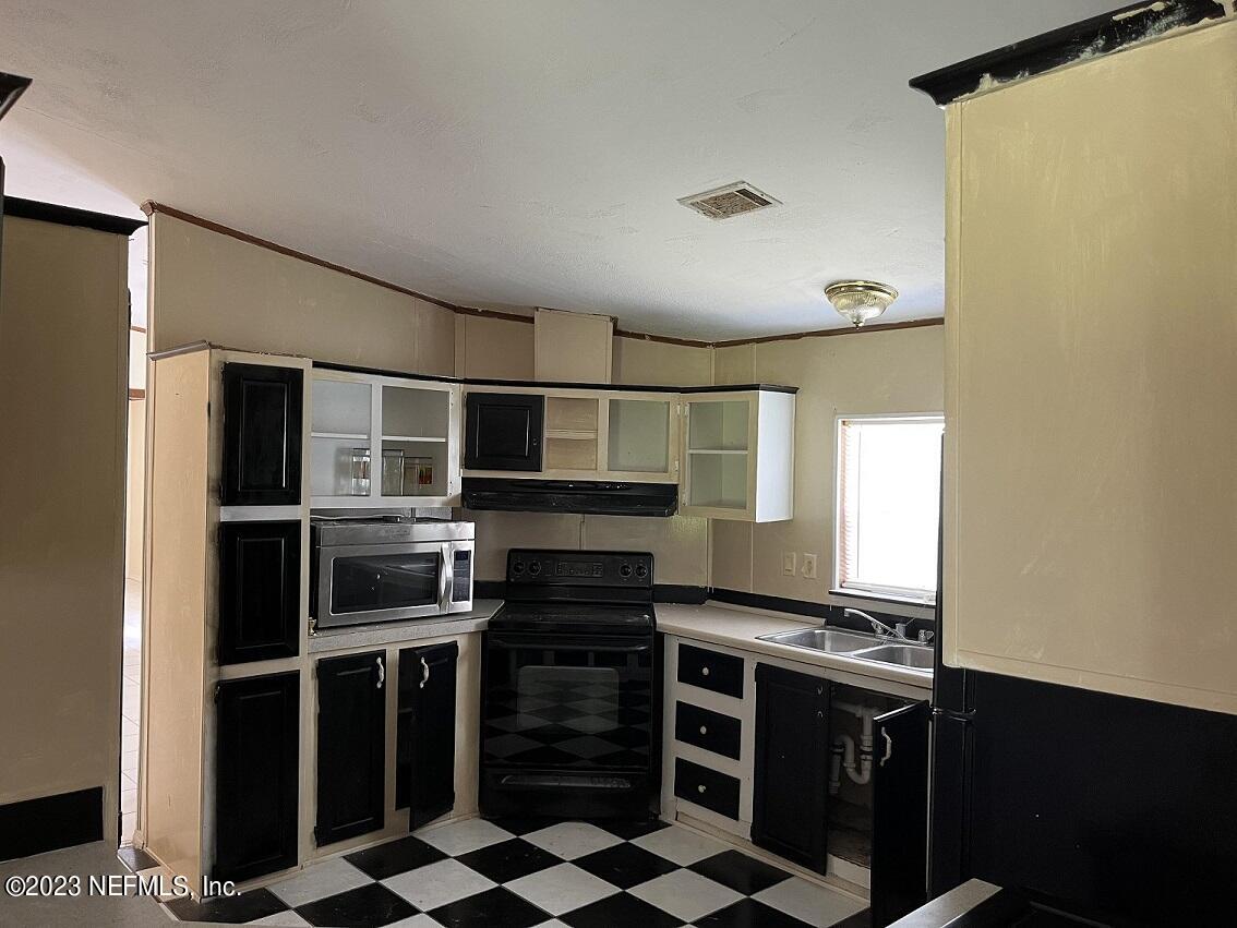 1370 Otis Road Jacksonville, FL 32220 - Photo 6 of 17 a kitchen with stainless steel appliances stove and cabinets