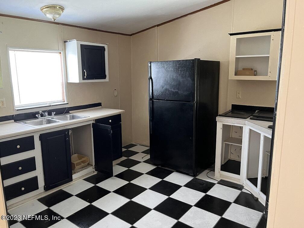 1370 Otis Road Jacksonville, FL 32220 - Photo 7 of 17 a kitchen with a stove a refrigerator and a sink