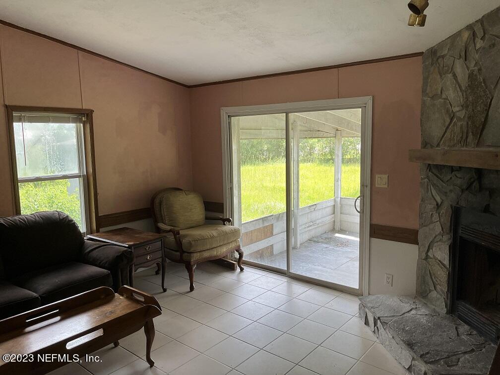 1370 Otis Road Jacksonville, FL 32220 - Photo 10 of 17 a living room with furniture and a fireplace