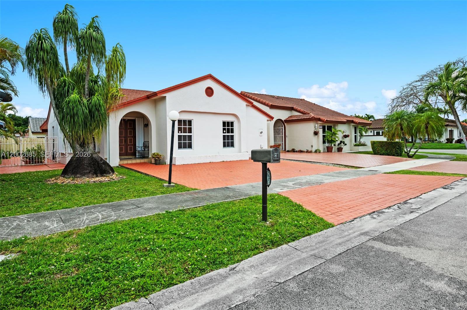 a front view of house with yard and green space