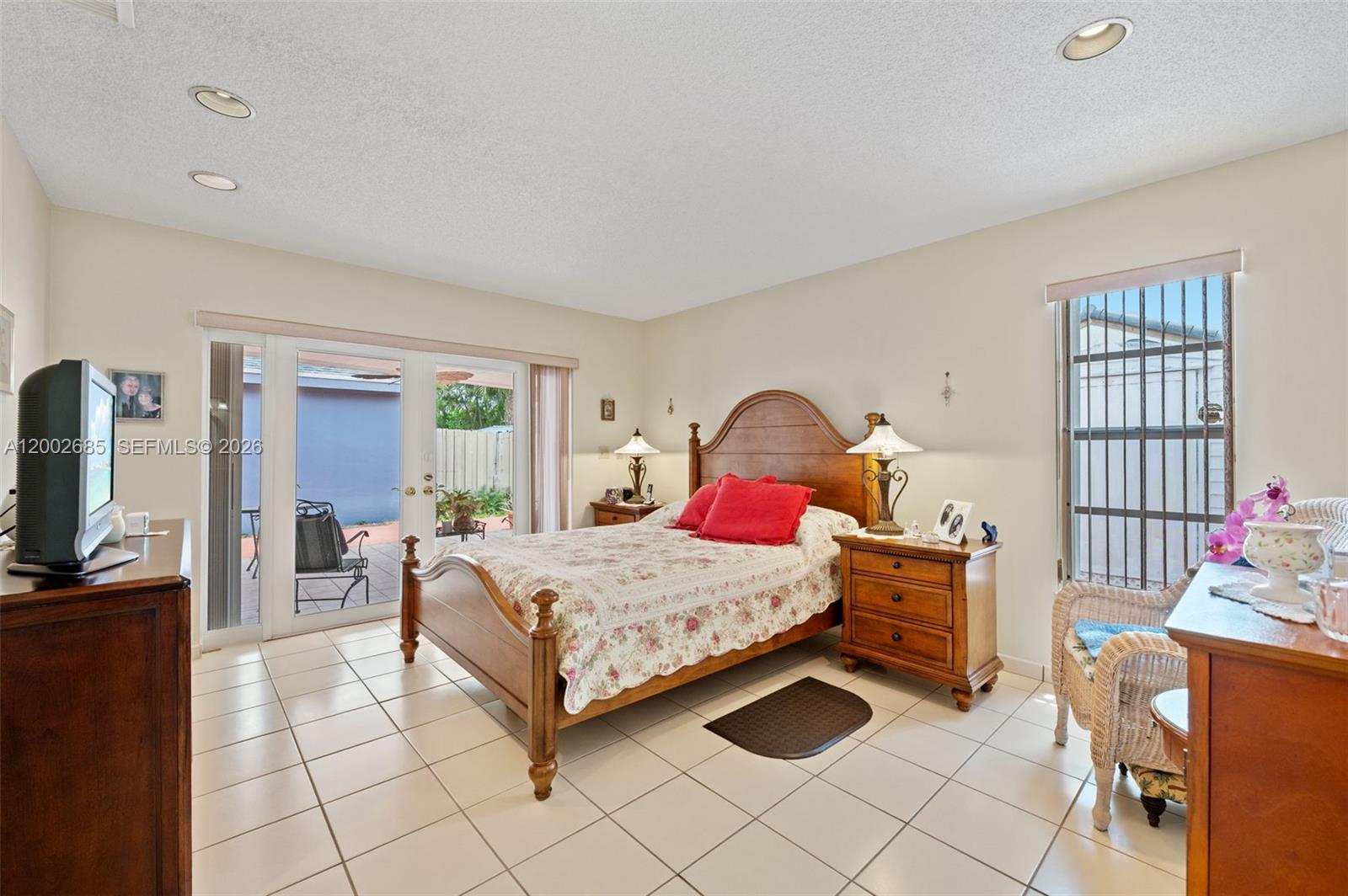 13440 Southwest 28th Street Miami, FL 33175 - Photo 13 of 35 a bedroom with a bed and a dresser in it