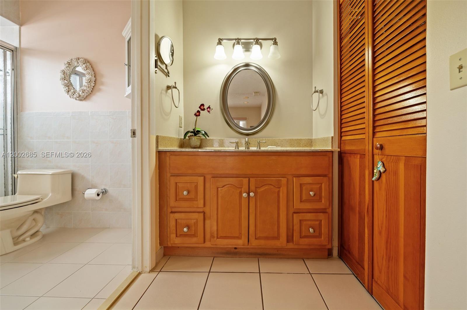 13440 Southwest 28th Street Miami, FL 33175 - Photo 15 of 35 a bathroom with a granite countertop sink a mirror and a shower
