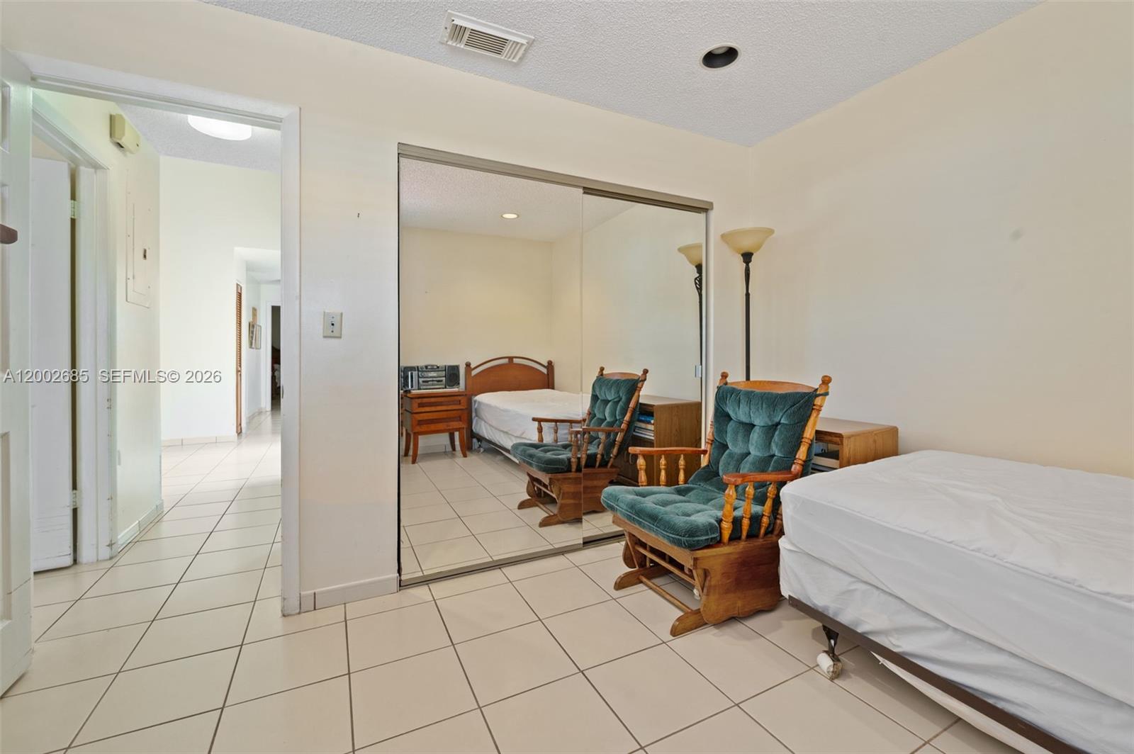 13440 Southwest 28th Street Miami, FL 33175 - Photo 18 of 35 a room that has a bed and chair in it