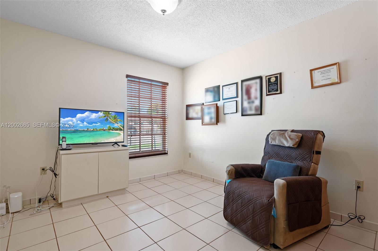 13440 Southwest 28th Street Miami, FL 33175 - Photo 19 of 35 a living room with furniture and a flat screen tv