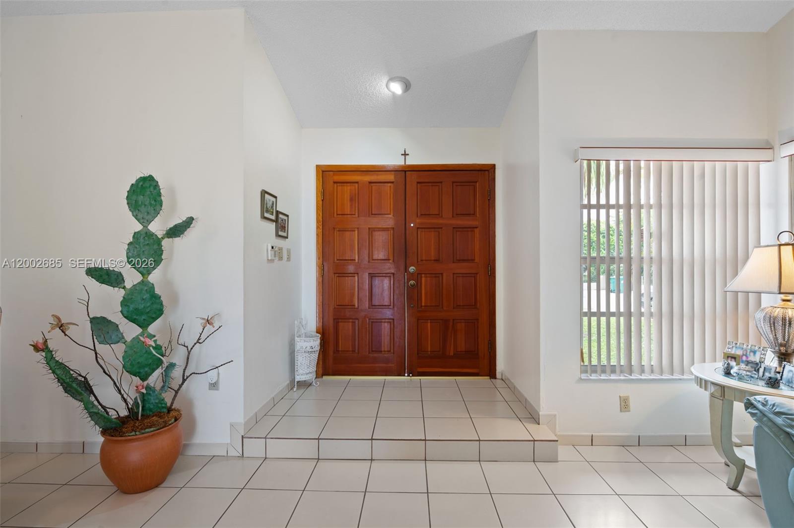 13440 Southwest 28th Street Miami, FL 33175 - Photo 2 of 35 a view of an entryway with table and window