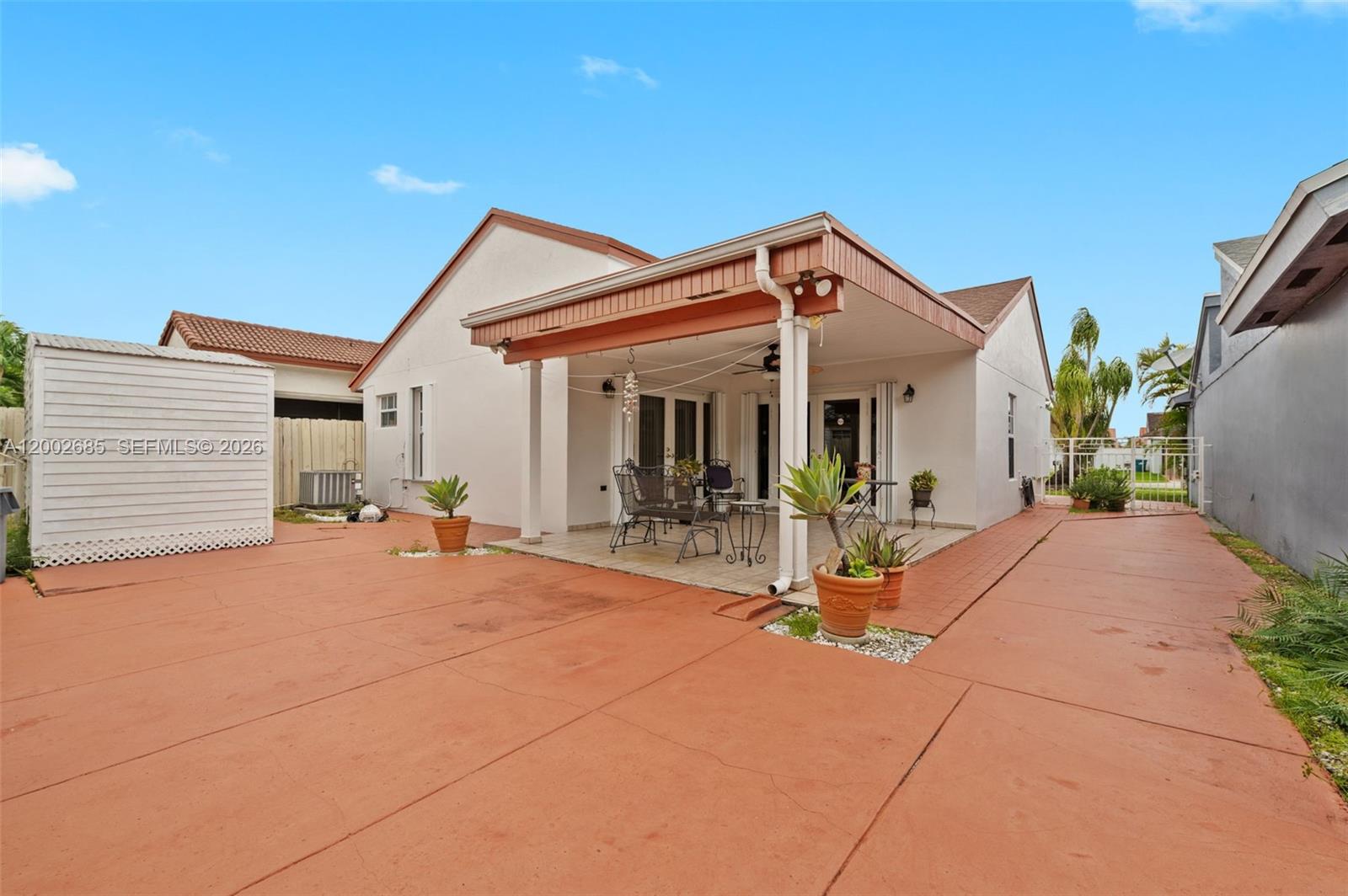 13440 Southwest 28th Street Miami, FL 33175 - Photo 23 of 35 a view of house and patio with swimming pool and porch