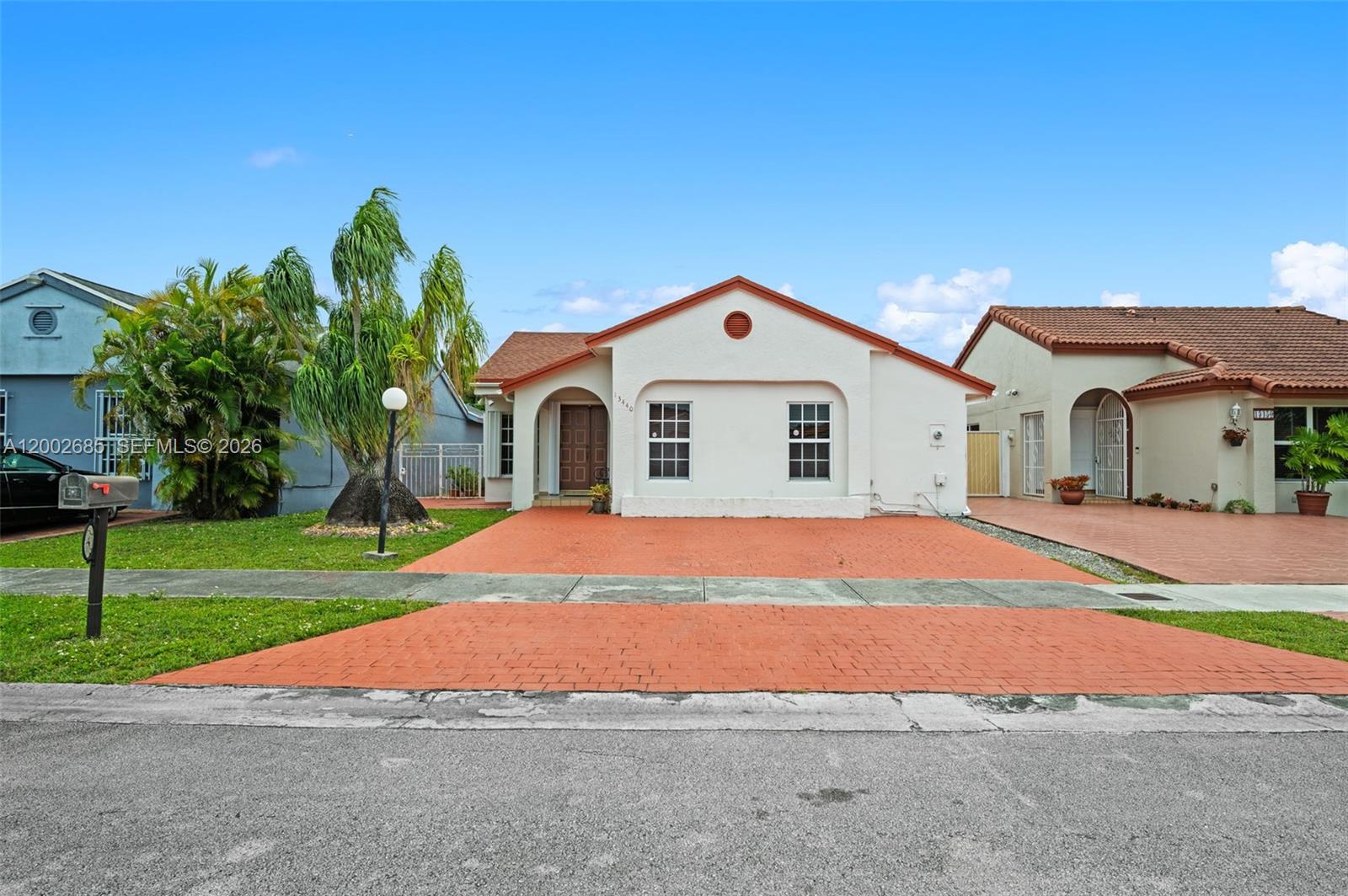 13440 Southwest 28th Street Miami, FL 33175 - Photo 35 of 35 a front view of a house with a yard and garage