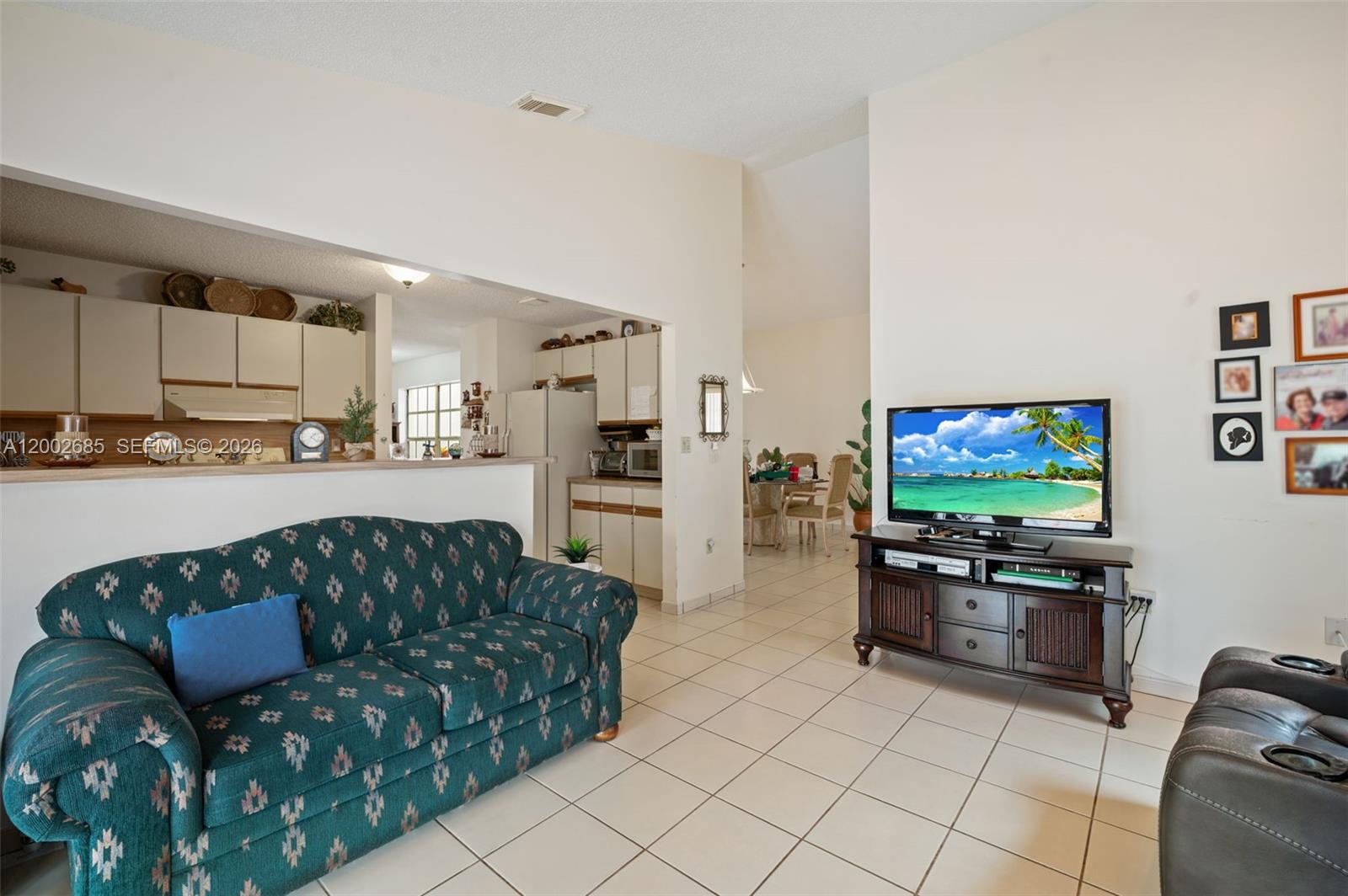 13440 Southwest 28th Street Miami, FL 33175 - Photo 5 of 35 a living room with furniture and a flat screen tv