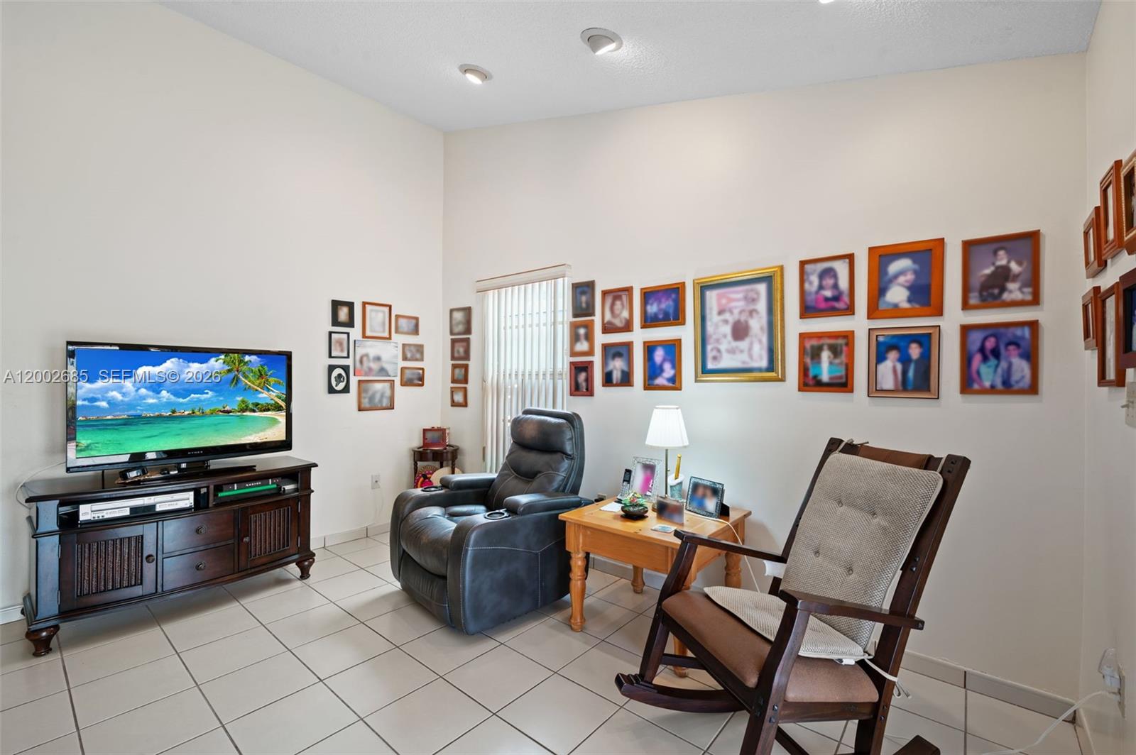 13440 Southwest 28th Street Miami, FL 33175 - Photo 7 of 35 a living room with furniture and a flat screen tv