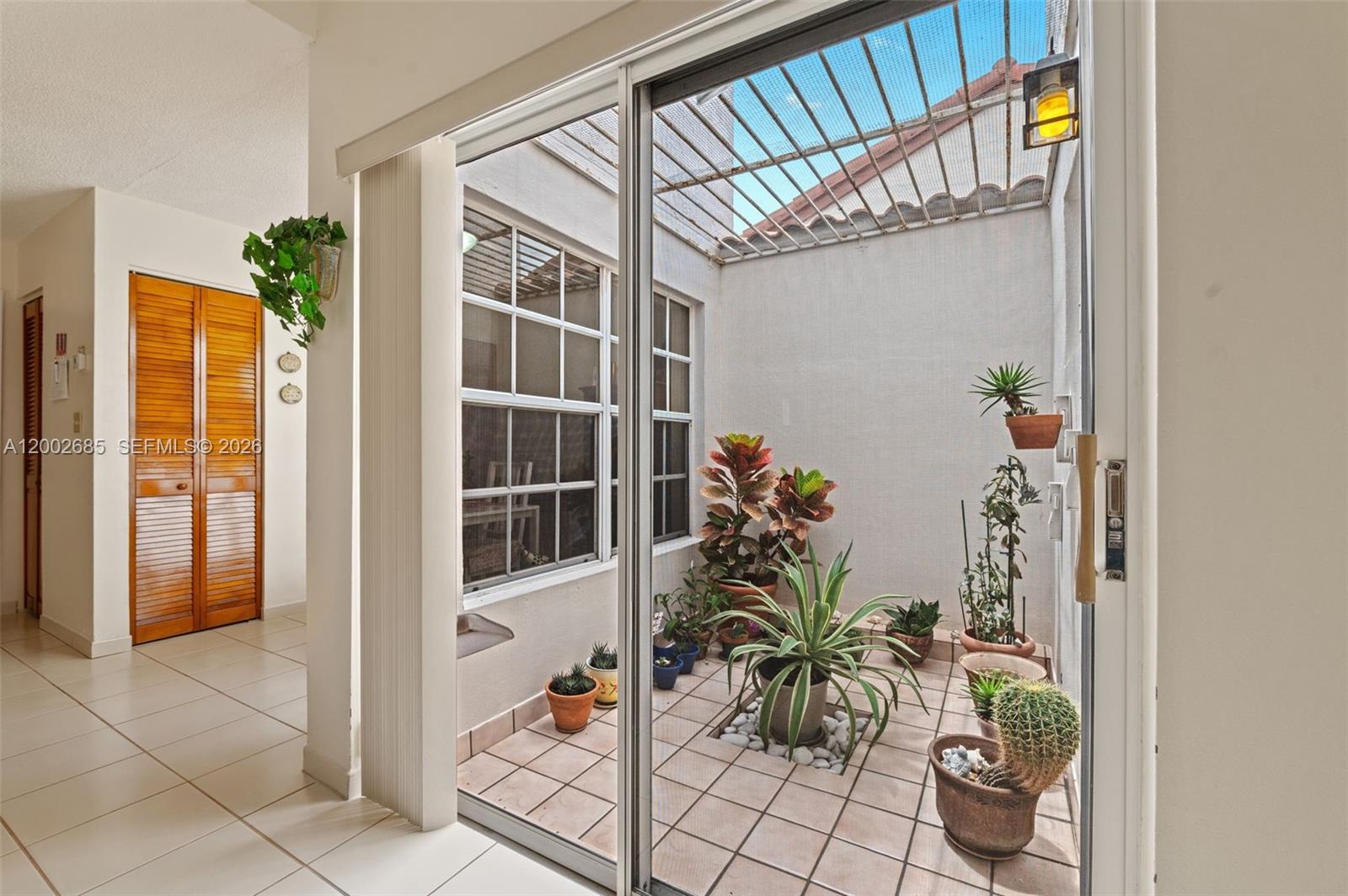 13440 Southwest 28th Street Miami, FL 33175 - Photo 9 of 35 a potted plant sitting in front of a door