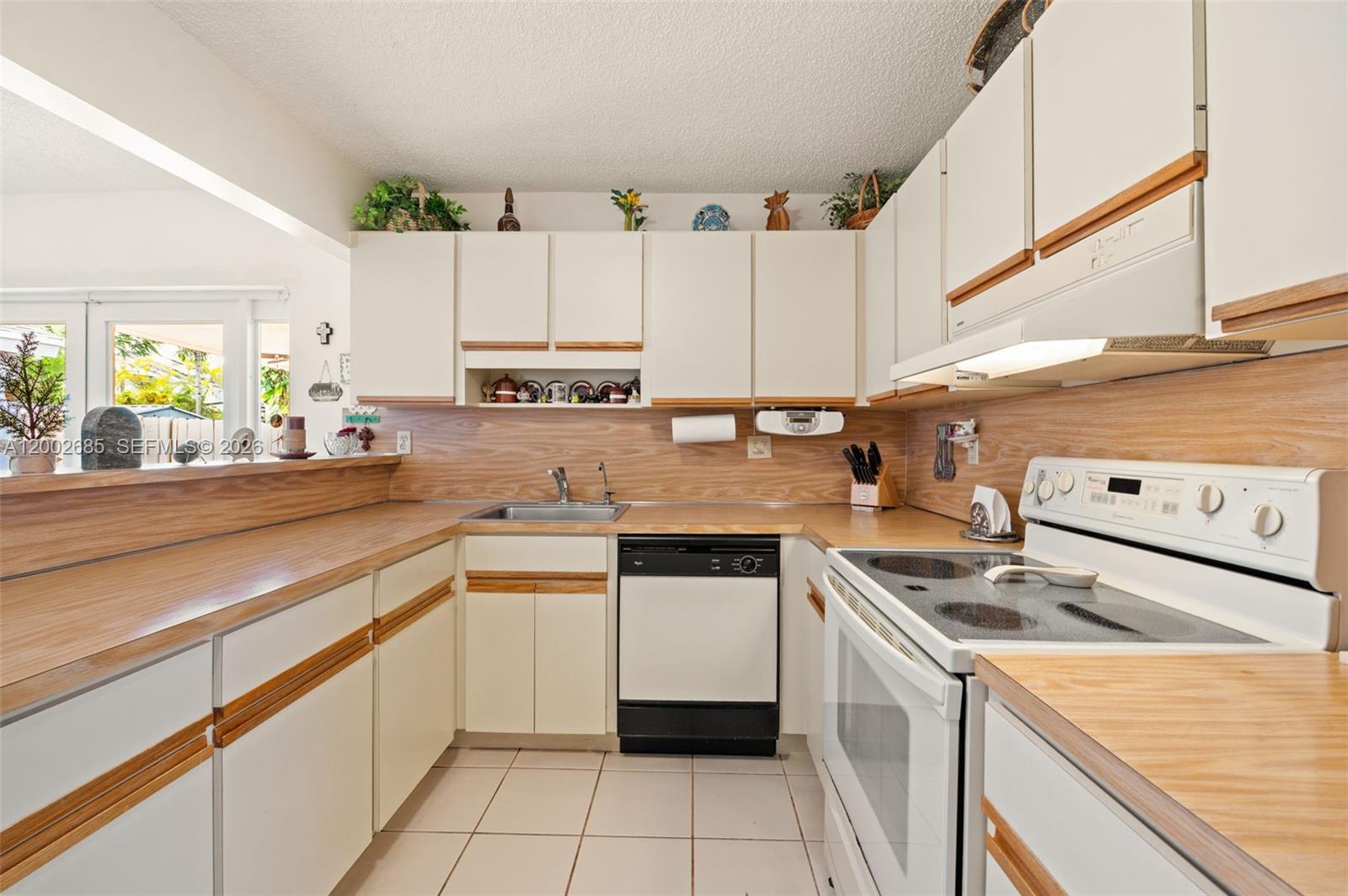 13440 Southwest 28th Street Miami, FL 33175 - Photo 10 of 35 a kitchen with a stove sink and cabinets