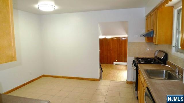48 Rock Road Englewood Cliffs, NJ 07632 - Photo 13 of 23 a kitchen that has a sink and a stove in it