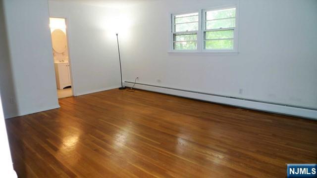 48 Rock Road Englewood Cliffs, NJ 07632 - Photo 15 of 23 an empty room with wooden floor and windows