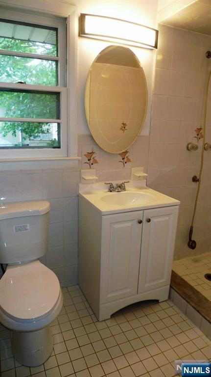 48 Rock Road Englewood Cliffs, NJ 07632 - Photo 16 of 23 a bathroom with a sink and a mirror