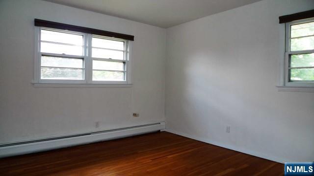 48 Rock Road Englewood Cliffs, NJ 07632 - Photo 20 of 23 an empty room with wooden floor and windows