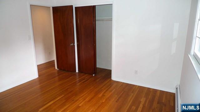 48 Rock Road Englewood Cliffs, NJ 07632 - Photo 21 of 23 an empty room with wooden floor