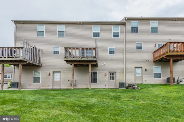 a view of a house with brick walls and a yard