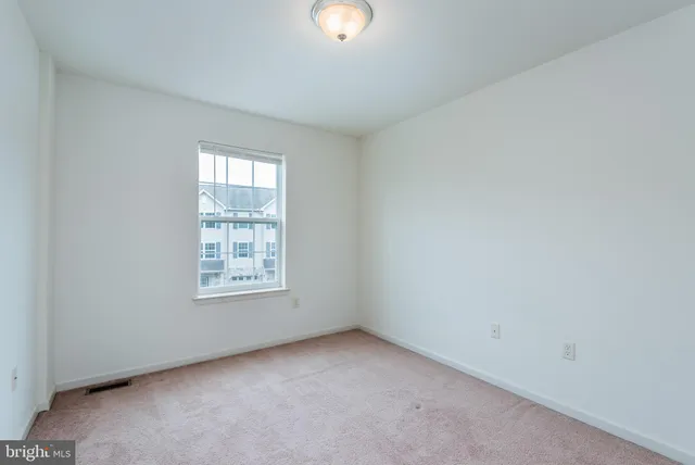 an empty room with window and windows