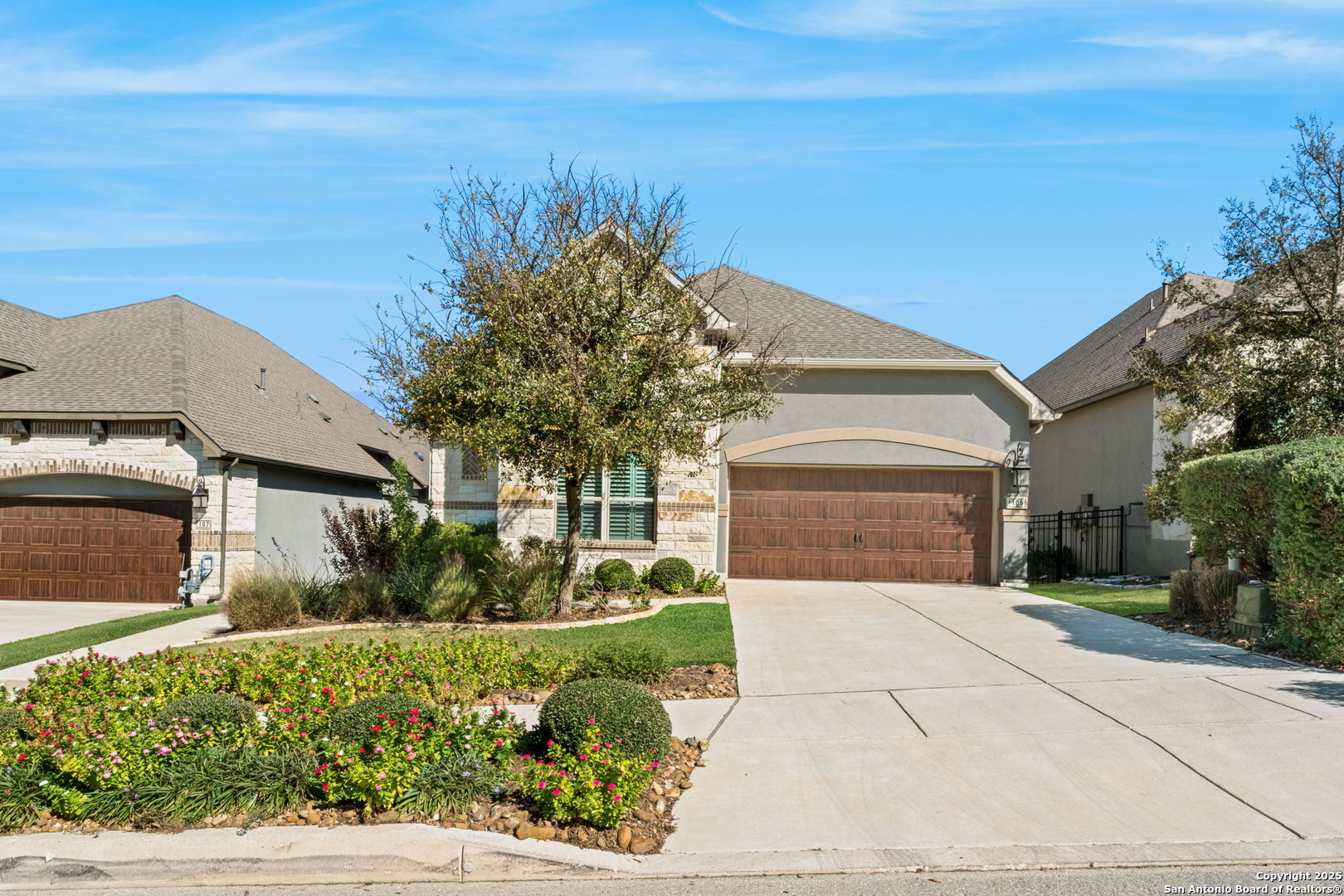 a front view of a house with a yard and garage