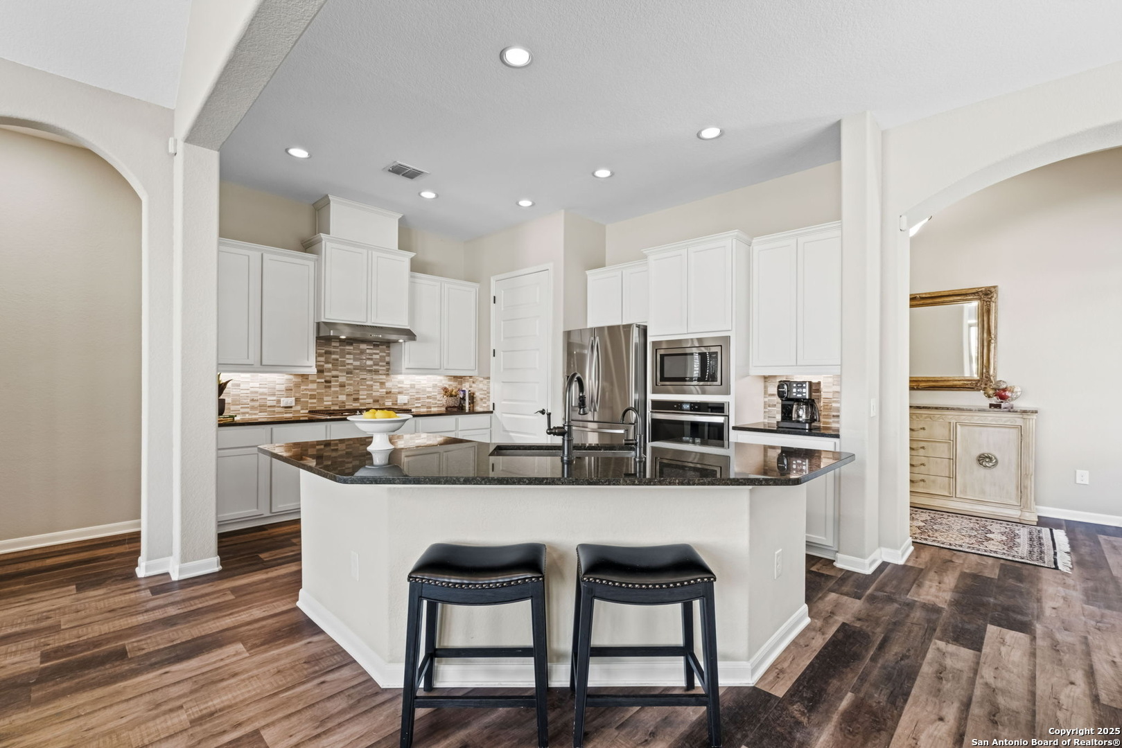 105 Gaucho Boerne, TX 78006 - Photo 11 of 29 a kitchen with stainless steel appliances kitchen island granite countertop a table chairs sink and cabinets