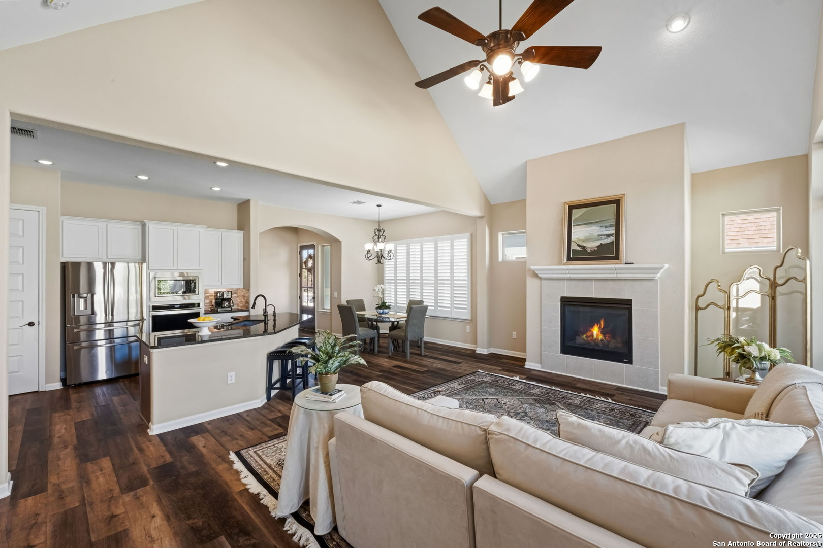 105 Gaucho Boerne, TX 78006 - Photo 18 of 29 a living room with stainless steel appliances furniture a fireplace and a ceiling fan
