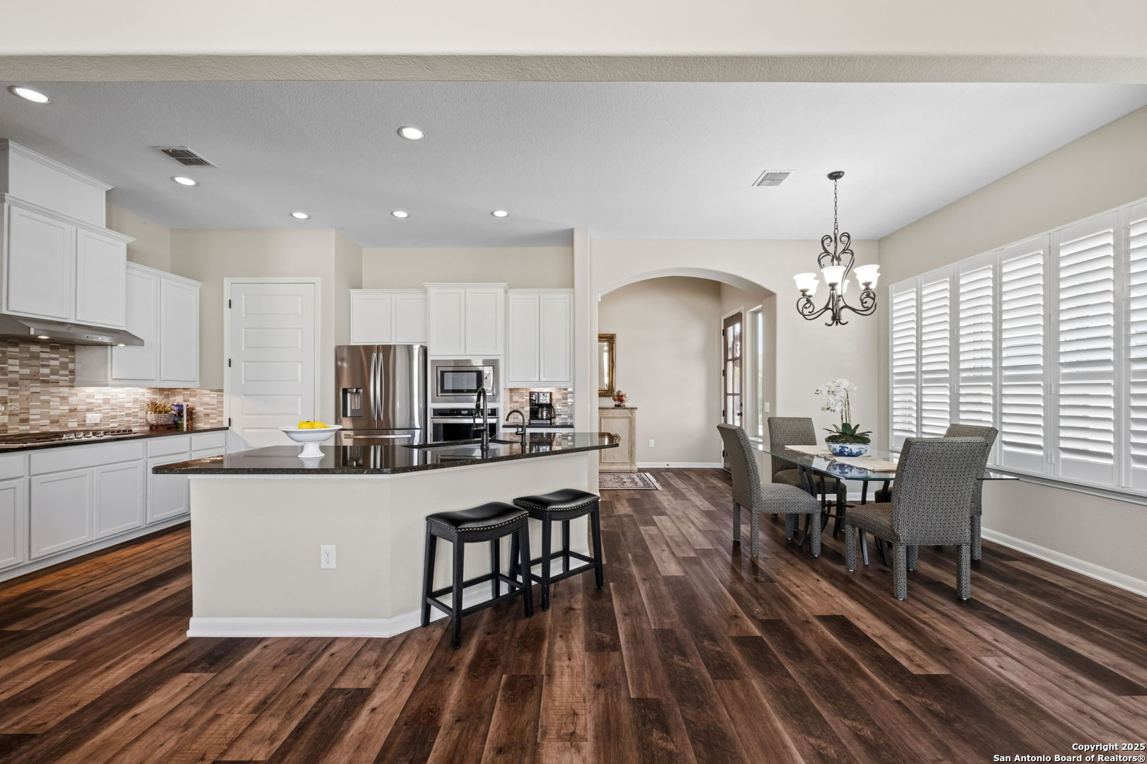 105 Gaucho Boerne, TX 78006 - Photo 4 of 29 a kitchen with stainless steel appliances granite countertop a dining table chairs stove a refrigerator and cabinets