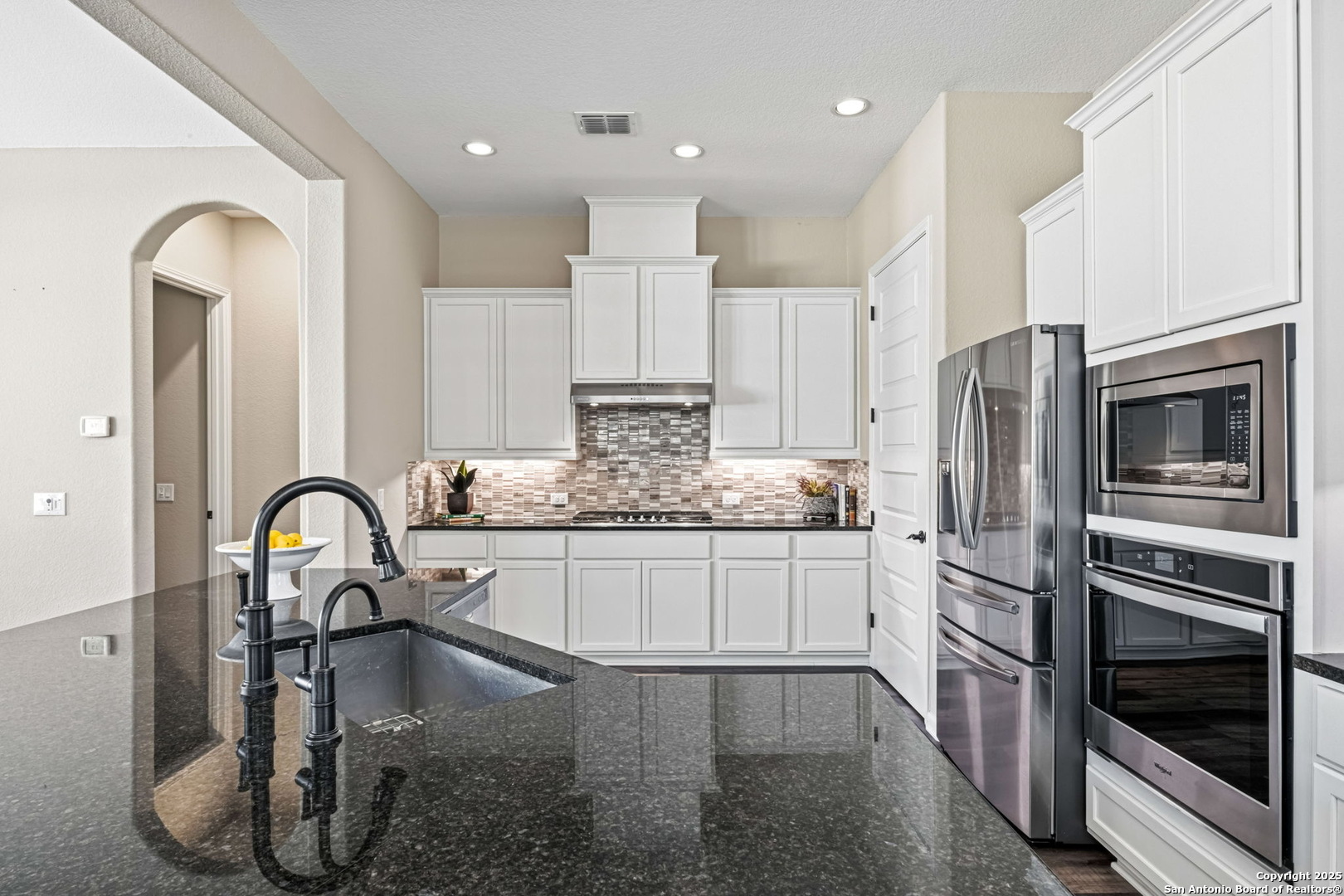 105 Gaucho Boerne, TX 78006 - Photo 7 of 29 a kitchen with stainless steel appliances granite countertop a stove a sink and a refrigerator