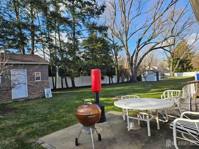 a view of a table and chairs in the garden