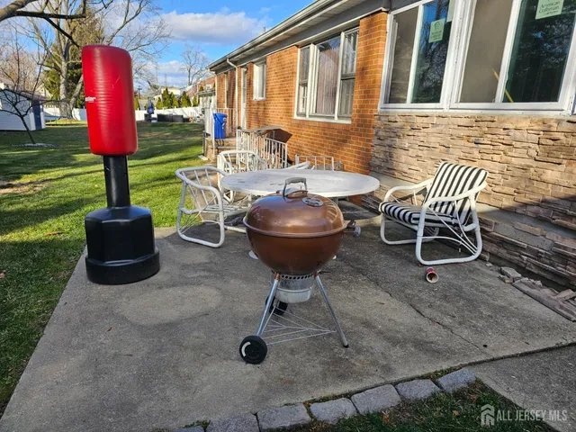 a view of a chairs and table in backyard