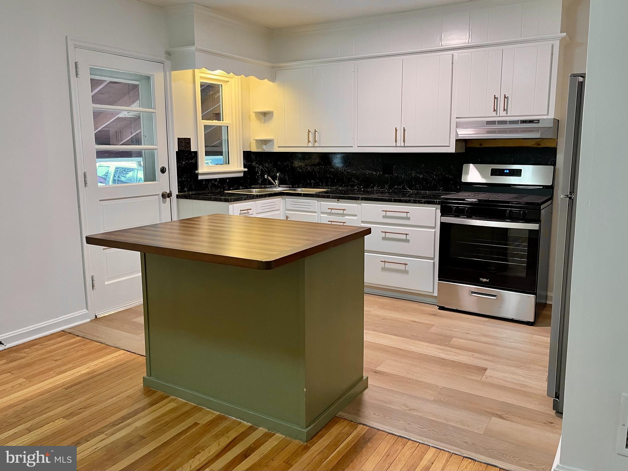 1136 Union Street Lancaster, PA 17603 - Photo 3 of 24 a kitchen with stainless steel appliances granite countertop a stove a sink and a microwave
