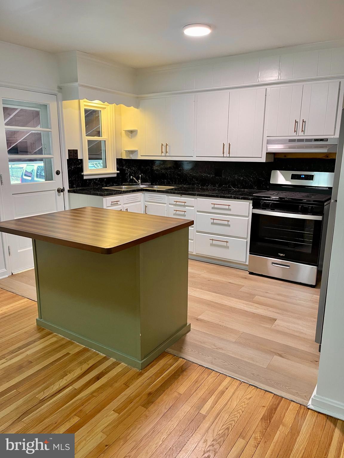 1136 Union Street Lancaster, PA 17603 - Photo 4 of 24 a kitchen with stainless steel appliances granite countertop a stove a sink and a microwave