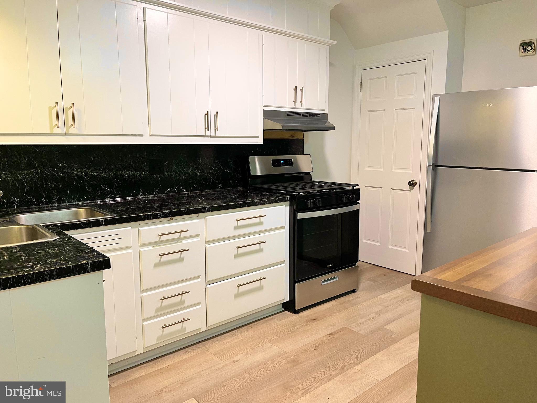 1136 Union Street Lancaster, PA 17603 - Photo 8 of 24 a kitchen with granite countertop white cabinets and stainless steel appliances