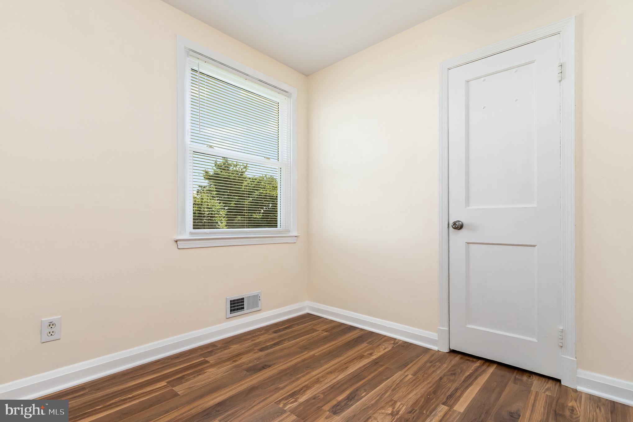 6301 Fieldvale Road Baltimore, MD 21237 - Photo 15 of 44 a view of an empty room with wooden floor and a window