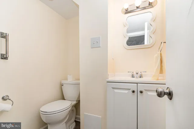 a bathroom with a toilet a sink and mirror