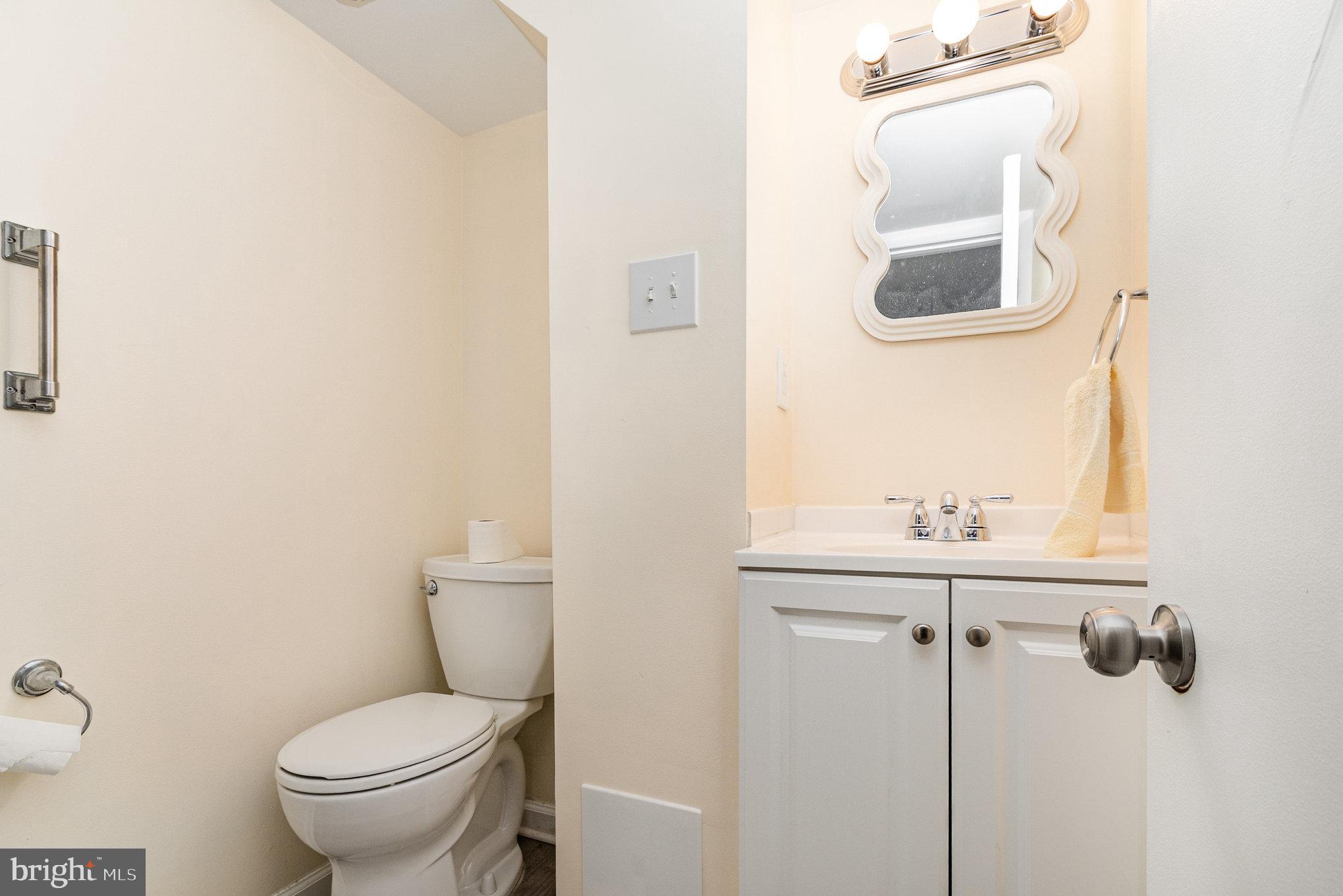 6301 Fieldvale Road Baltimore, MD 21237 - Photo 24 of 44 a bathroom with a toilet a sink and mirror