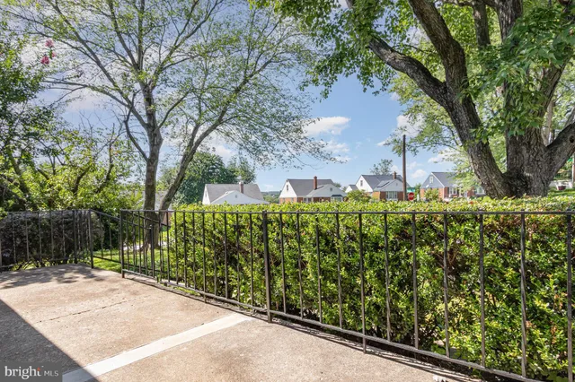 a view of a house with a tree in front of it
