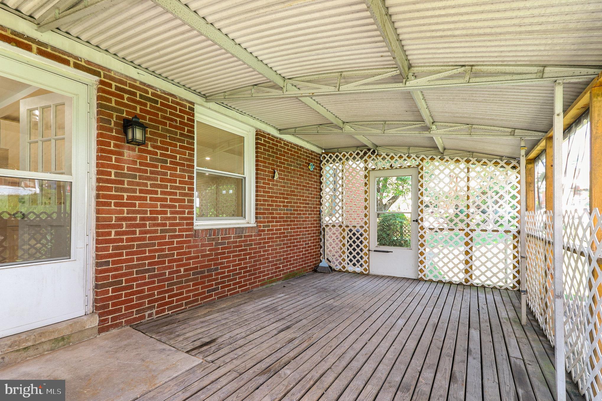 6301 Fieldvale Road Baltimore, MD 21237 - Photo 34 of 44 a view of a porch with wooden floor and floor to ceiling window