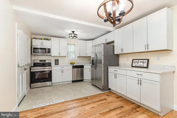 a view of a kitchen with a sink and a refrigerator