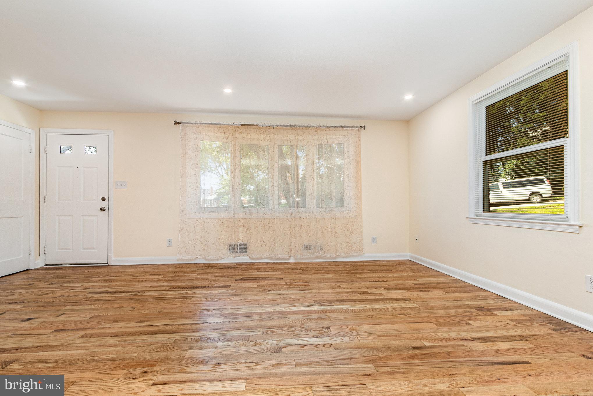 6301 Fieldvale Road Baltimore, MD 21237 - Photo 8 of 44 a view of an empty room with wooden floor and a window
