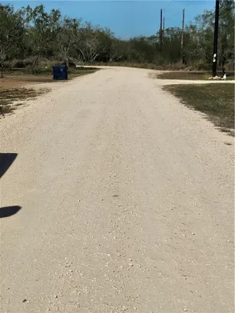 a view of a dry yard with mountains in the background
