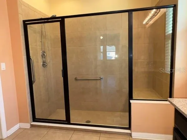 a bathroom with a glass shower door