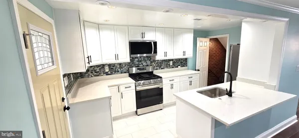 a kitchen with a refrigerator and a sink